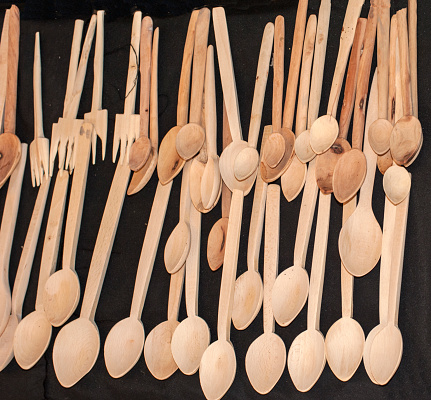 Handmade wooden Spoons and forks on black background