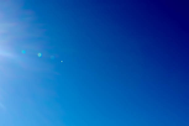 Blue sky bright summer rays of the sun stock photo
