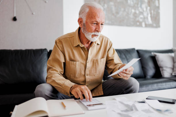 istock Senior man checking bills at home 1410593746