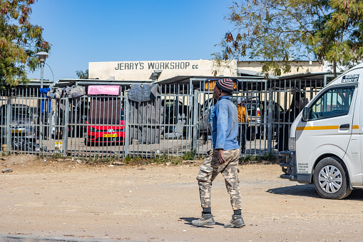 A man walking near Jerry's Workshop at Greenwell Matongo near Windhoek at Khomas Region, Namibia