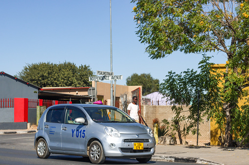 People walking near a Taxi at Independence Avenue and Psalm Street in Katutura Township near Windhoek at Khomas Region, Namibia