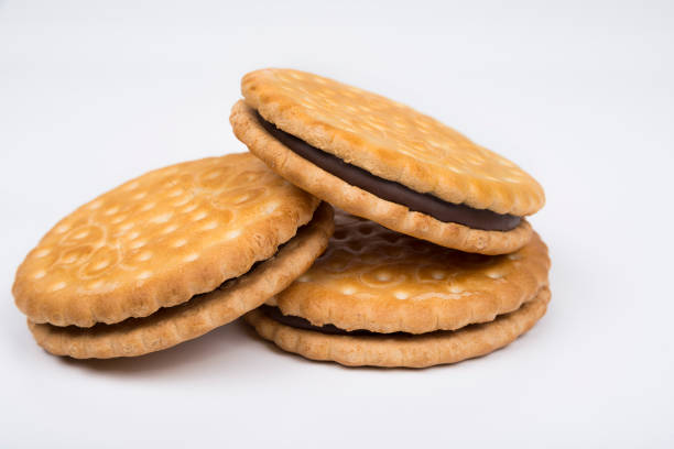Crispy sandwich biscuits with fluffy cream on a white