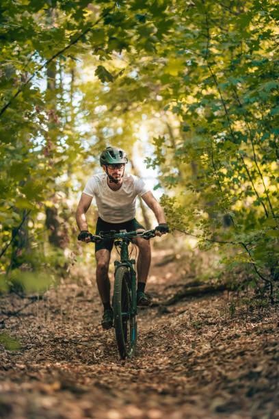 istock mountain biker riding his bike throught the mountain 1410605007