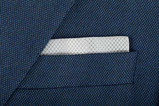 Close up picture of a blue suit with a  gary tissue in it