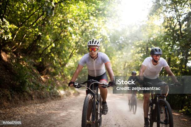 Group Of Mountainbikers Riders Biking Outdoor Up Mountain Stock Photo - Download Image Now