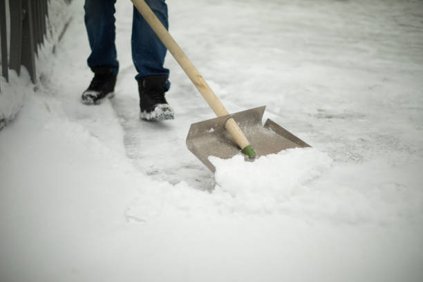 istock Shovel snow removal. Tool for cleaning snowdrift. Janitor cleans road from precipitation. 1410608514