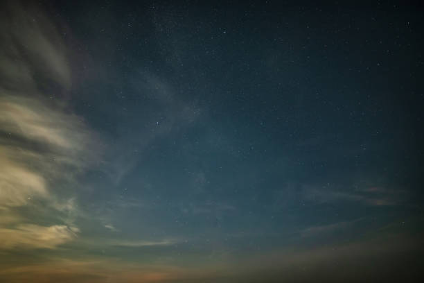 istock Beautiful noctilucent cloud formations against Milky Way background night sky 1410608660