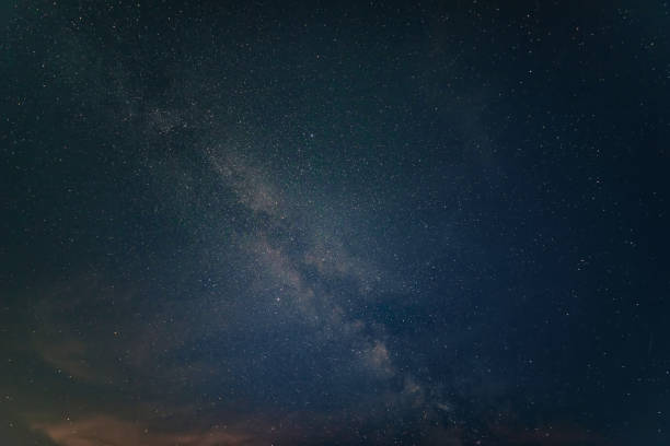 istock Beautiful noctilucent cloud formations against Milky Way background night sky 1410608810