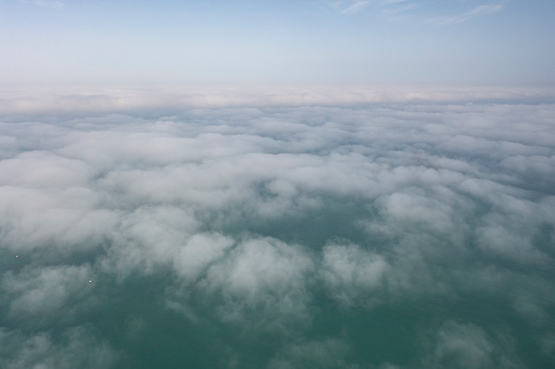 Clouds over sea. Foggy weather over sea. Top view of sea. Aerial view. Sea mist