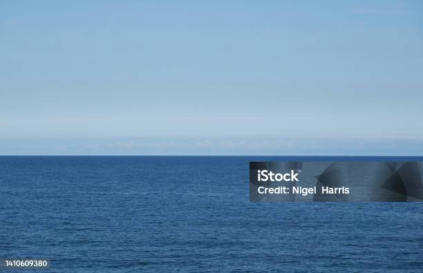 A Tranquil View Of The Calm North Sea Off The Coast Of England Under A Light Blue Sky Stock Photo - Download Image Now