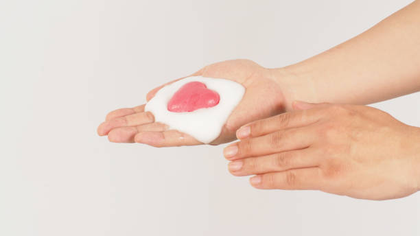 istock Hands washing with foaming and pink soap on white background. Studio shot 1410609548