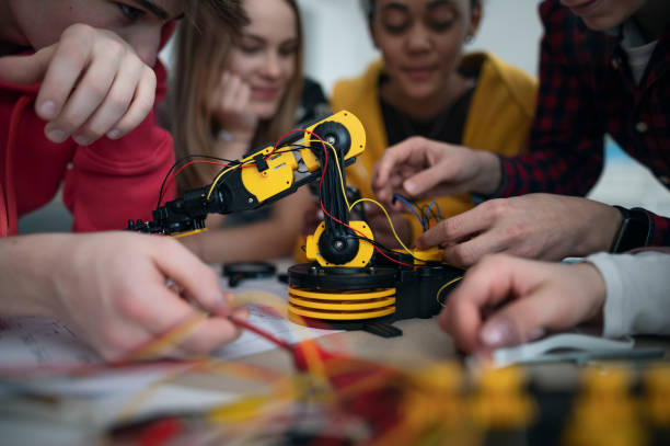 istock Group of students building and programming electric toys and robots at robotics classroom 1410609654