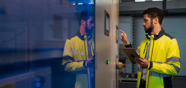 istock Young industrial worker operating cnc machine at metal machining industry 1410610941