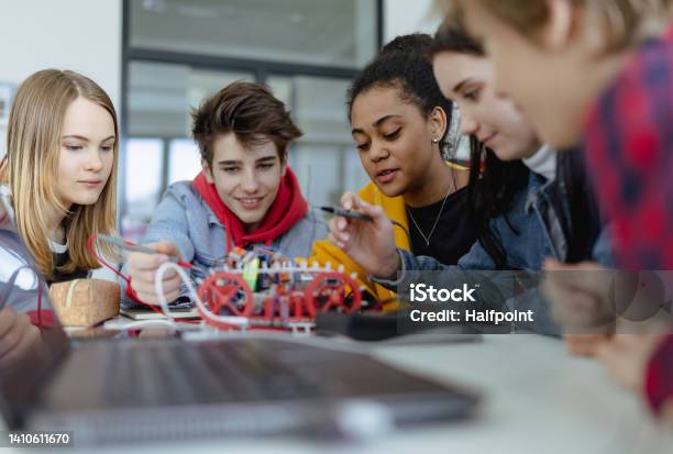 Group Of High School Students Building And Programming Electric Toys And Robots At Robotics Classroom Stock Photo - Download Image Now