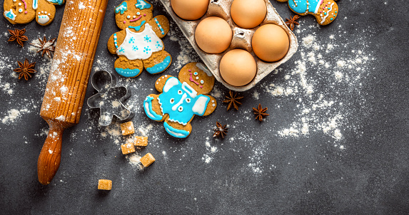 Christmas gingerbread on dark background top view. Xmas holiday celebration and cooking concept