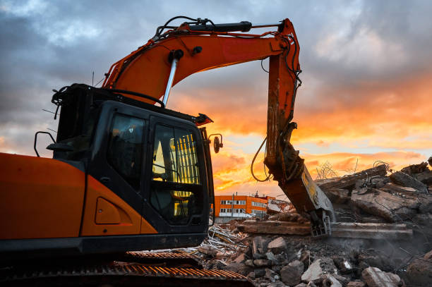 istock Excavator with crusher presses pile of reinforced cement 1410614441