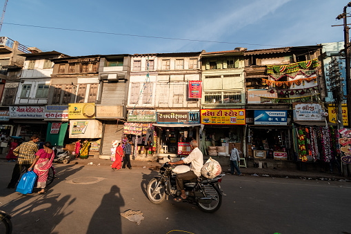 Bhavnagar, Gujarat, India - November 2018: Old shop houses in a busy market street in the old town area of Bhavnagar.