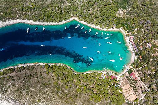 Paklinski, also called Pakleni, islands with all their amazing bays and incredible shades of blue-emerald colors and with many anchored yachts and boats seen from a different perspective and captured with a drone during summer vacation in Croatia.