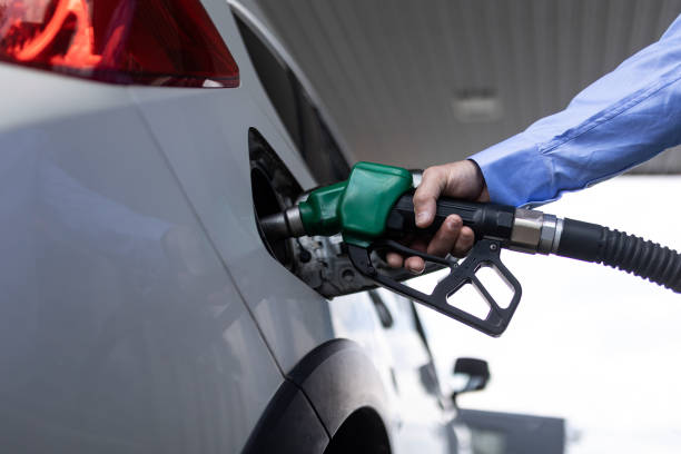 istock Hand refilling the car with fuel at the refuel station 1410618250