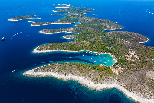Paklinski, also called Pakleni, islands with all their amazing bays and incredible shades of blue and emerald colors seen from a different perspective and captured with a drone during busy summer season in Croatia on the Adriatic Sea.