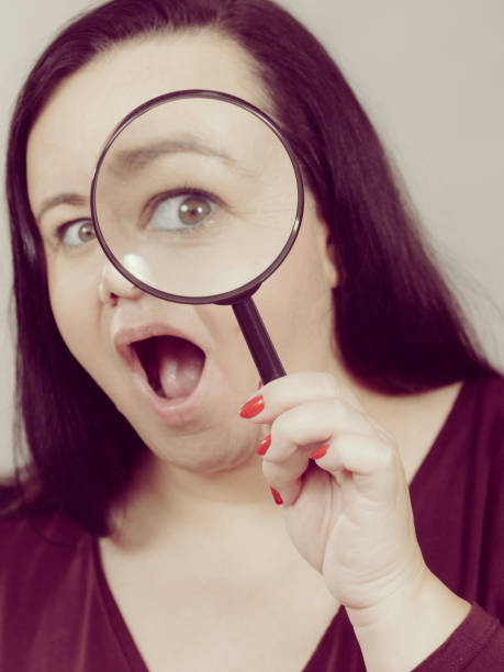 istock Adult woman with magnifying glss 1410619659