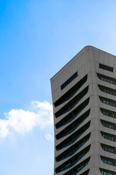 istock Curved skyscraper with long balcony, blue sky with one cloud. 1410619731