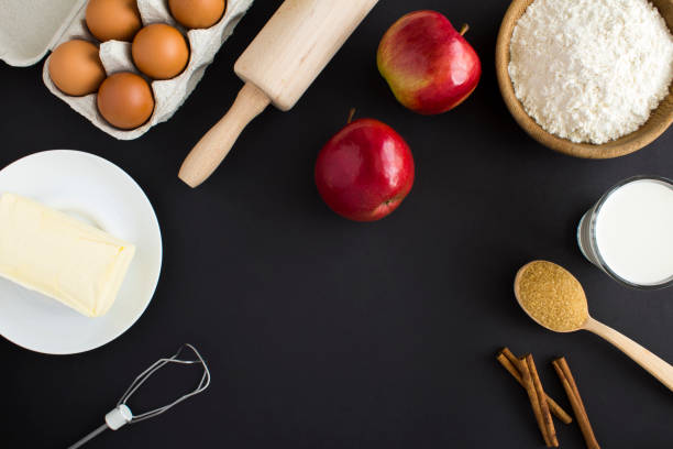 istock Top view of ingredients for making apple pie or cake on the black background. Copy space. 1410620131