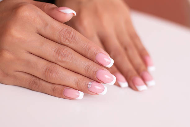 istock Beautiful female hands with french manicure 1410620255