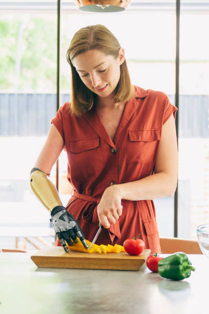 istock Young British woman chopping vegetables for midday meal 1410620264