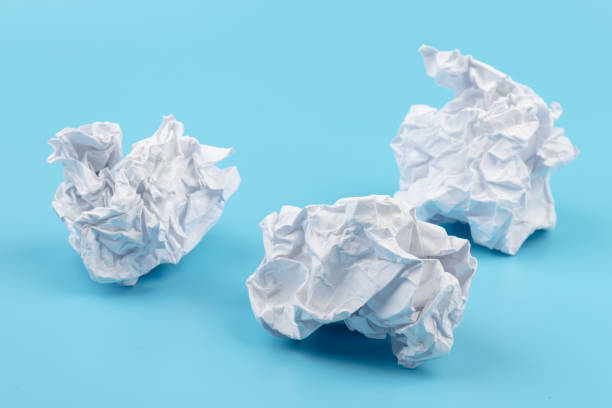 istock A piece of crumpled white paper on a blue background. 1410622589