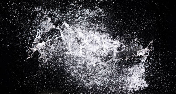 istock Water splash in air drop over black background, studio lighting high speed 1410622846