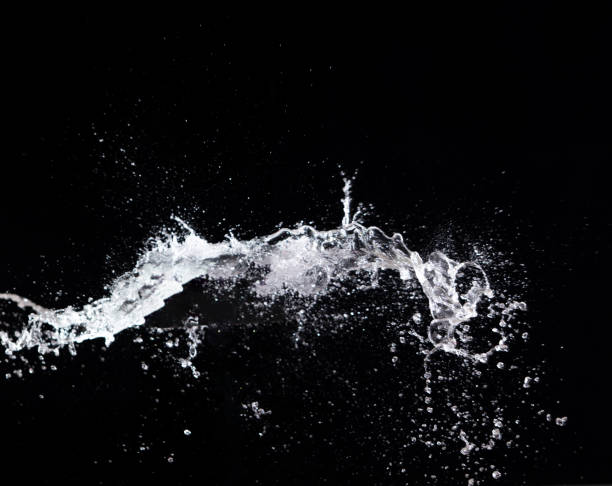 istock Water splash in air drop over black background, studio lighting high speed 1410622863
