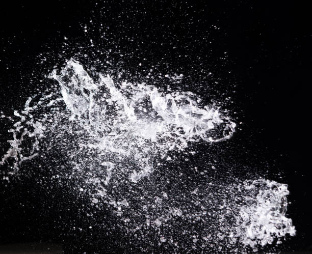 istock Water splash in air drop over black background, studio lighting high speed 1410622944