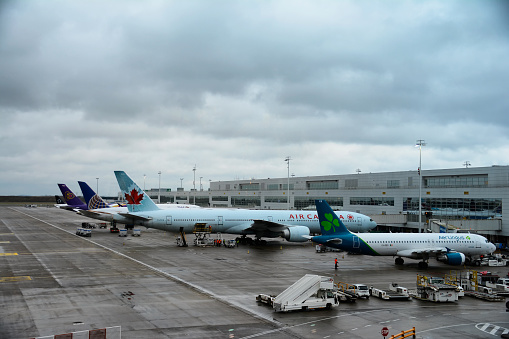 Brussels, Belgium - December 30, 2021: airplanes of the companies Aer Lingus and Air Canada in the boarding area.