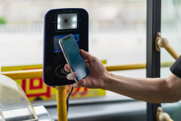 istock Man using mobile phone to pay for bus fare 1410627485