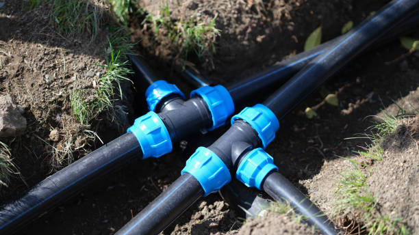 Connecting HDPE plastic water pipes in garden closeup Connecting HDPE plastic water pipes in garden. Irrigation system and plastic pipes in ground pvc conduit stock pictures, royalty-free photos & images