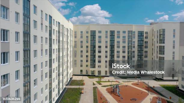 Aerial View Of A Modern Residential Buildings And An Empty Children Playground Video Newly Built White House On Summer Blue Cloudy Sky Background Stock Photo - Download Image Now