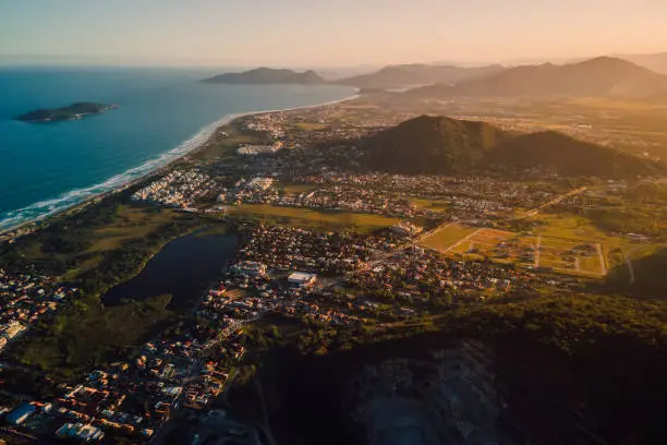 Ocean coastline and town with sunset lights in Campeche, Florianopolis