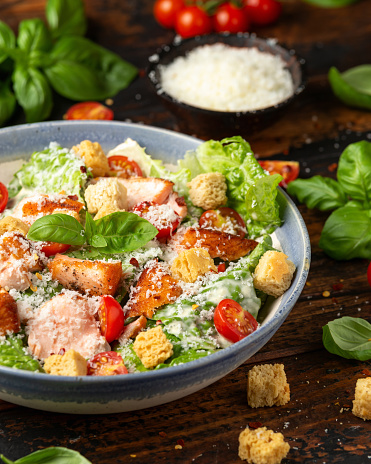 Salmon Caesar salad with grilled fish, croutons and cherry tomatoes.