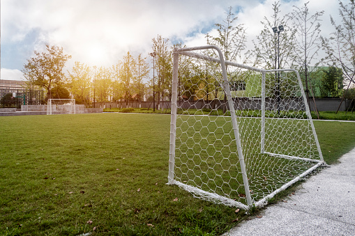 this color image is of a Corner Kick at Soccer Field during Soccer Game. the corner kick area is drawn out in white chalk on the lush green grass. the soccer field is made of lush green grass or artificial turf. the picture was taken during a live soccer match or soccer game or sporting event. this picture was taken during soccer season