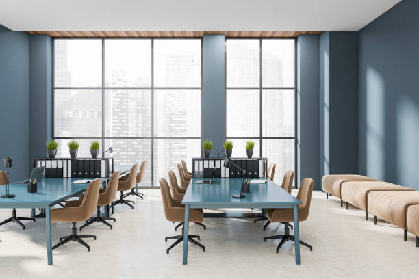 istock Workplace interior with laptop on desk, couch and panoramic window on city view 1410638772