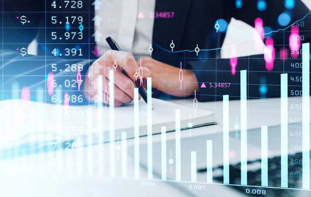 istock Businesswoman take note in notebook on desk in office, forex diagrams 1410640208