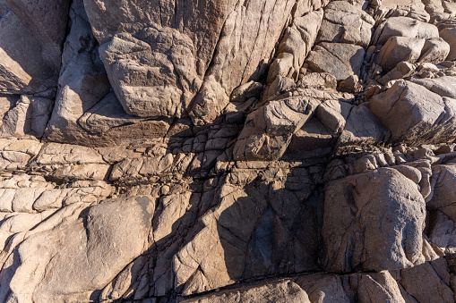 Textures and cracks of naturally weathered seaside rocks