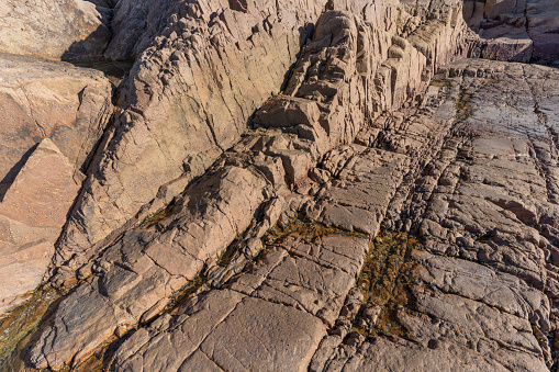 Textures and cracks of naturally weathered seaside rocks
