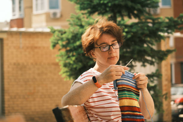 istock Woman knitting outdoors 1410640459