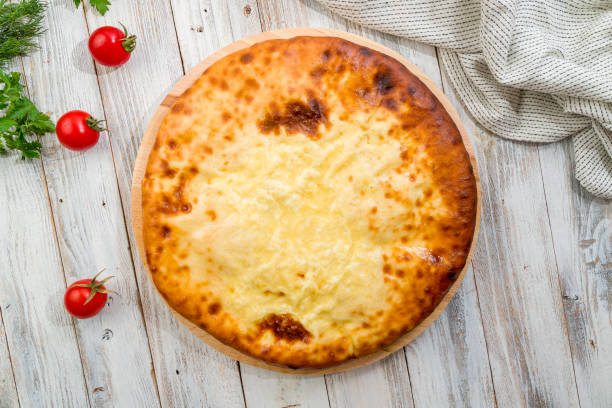 istock Ossetian pie with cheese on white wooden table 1410642263
