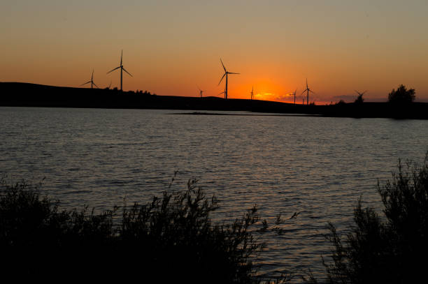 istock Wind generators producing electricity against the backdrop of the setting sun. 1410643582