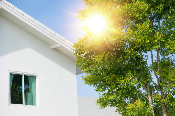the tree help home cooling and protect heat from sun light. green eco house village concept stock photo