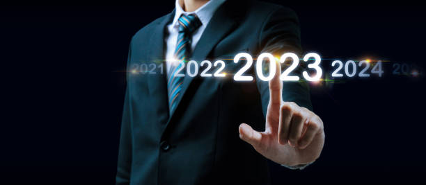 istock 2023. businessman hand touching and pointing on year 2023 with virtual screen on dark background, goal target, change from 2022 to 2023, strategy, investment, business planning, happy new year concept 1410648908