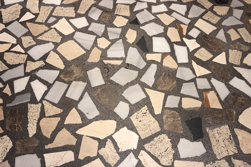 Texture of a pavement of colored marble pieces.